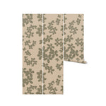Three vertical panels displaying the Little Flowers Wallpaper. Each panel features the uniform pattern of dark green flowers against the beige backdrop, showcasing the wallpaper's potential to bring continuity and a touch of nature to any room. The panels illustrate how the wallpaper can be used to enhance both small and large spaces with its graceful design.
