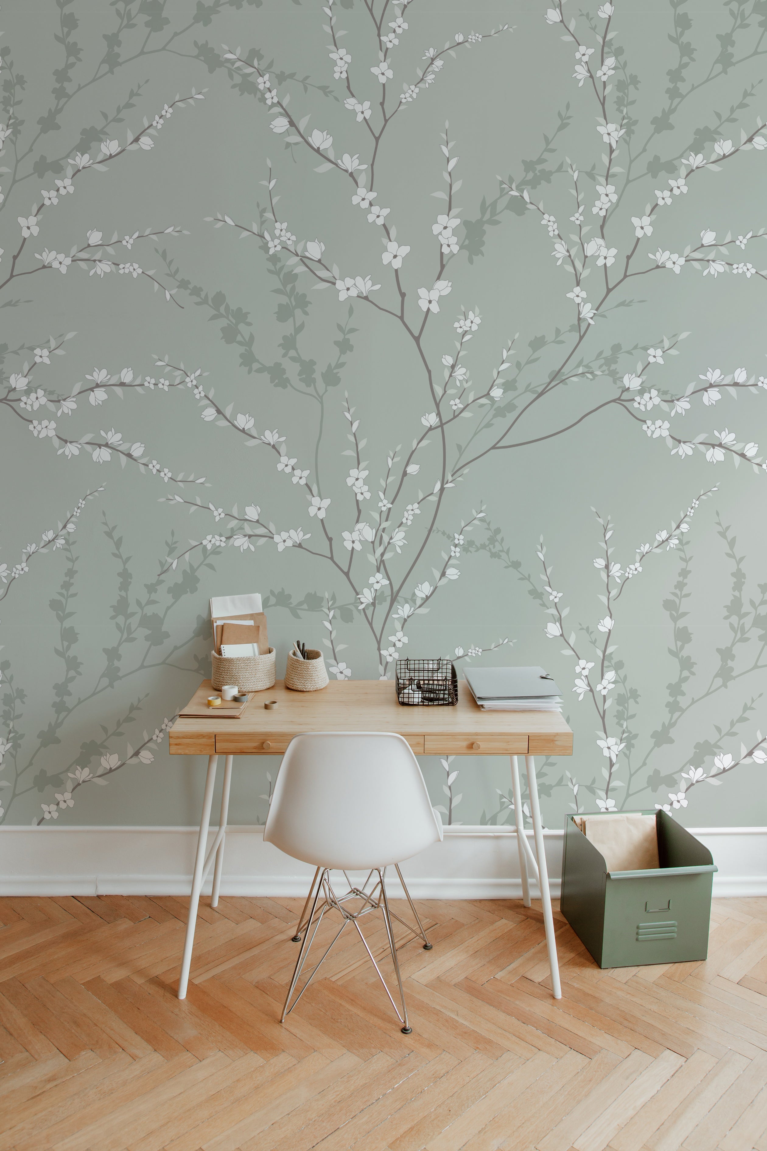A modern workspace elegantly enhanced by the Enchanted Blossoms Wallpaper. The wallpaper forms a beautiful backdrop behind a minimalist wooden desk paired with a white modern chair. Simple office supplies and a vintage-inspired lamp complete the setup, emphasizing the wallpaper's ability to blend naturally into a stylish and functional area.