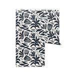 A mockup of a roll of Dark Bloom Wallpaper, displaying the bold black abstract floral and leaf design on a white background.
