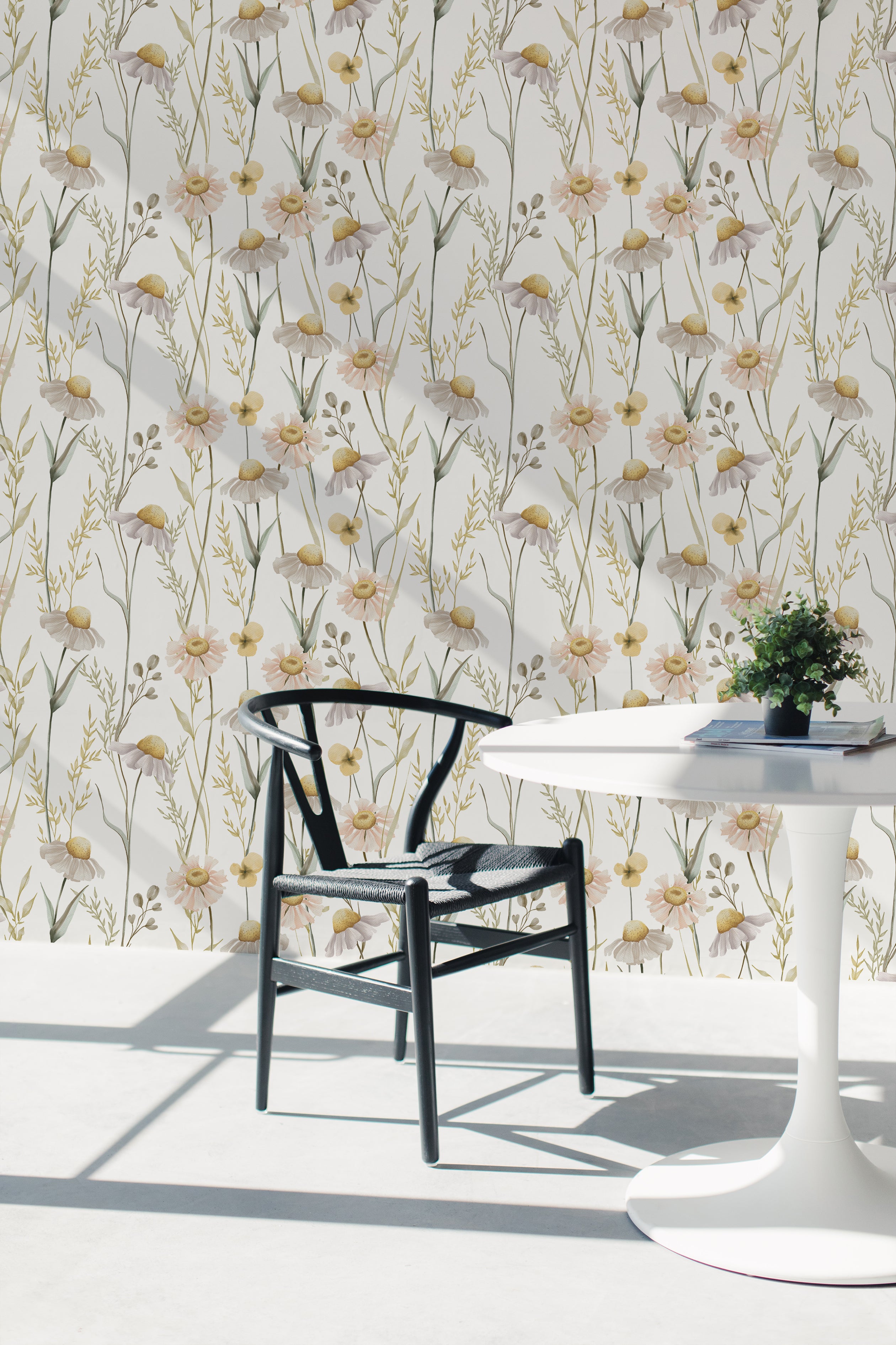 Modern dining room interior featuring Chamomile Wallpaper, which adds a fresh and natural touch with its detailed chamomile flower pattern in soft pastel colors. A black chair and white round table complement the serene and inviting atmosphere.