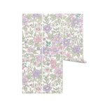A roll of whimsical floral wallpaper showcasing a design of pastel-colored flowers in shades of pink, lavender, and green. The pattern creates a soft and charming aesthetic on a light background, perfect for adding a touch of playfulness to any room.