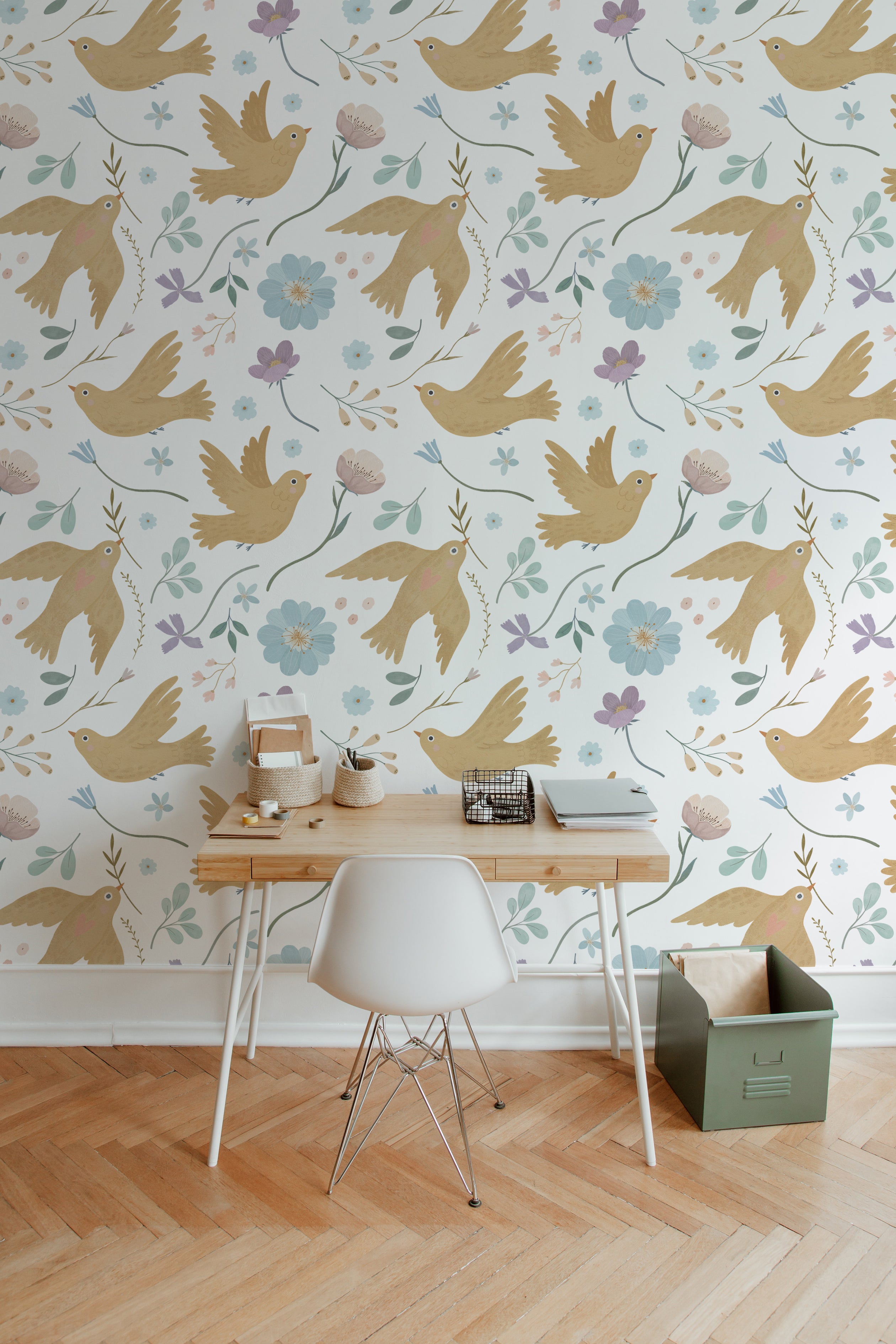 Interior view of a room with Pastel Bird Wallpaper - Large, showcasing a cozy workspace with a wooden desk and white chair against a backdrop of tan birds and pastel flowers.