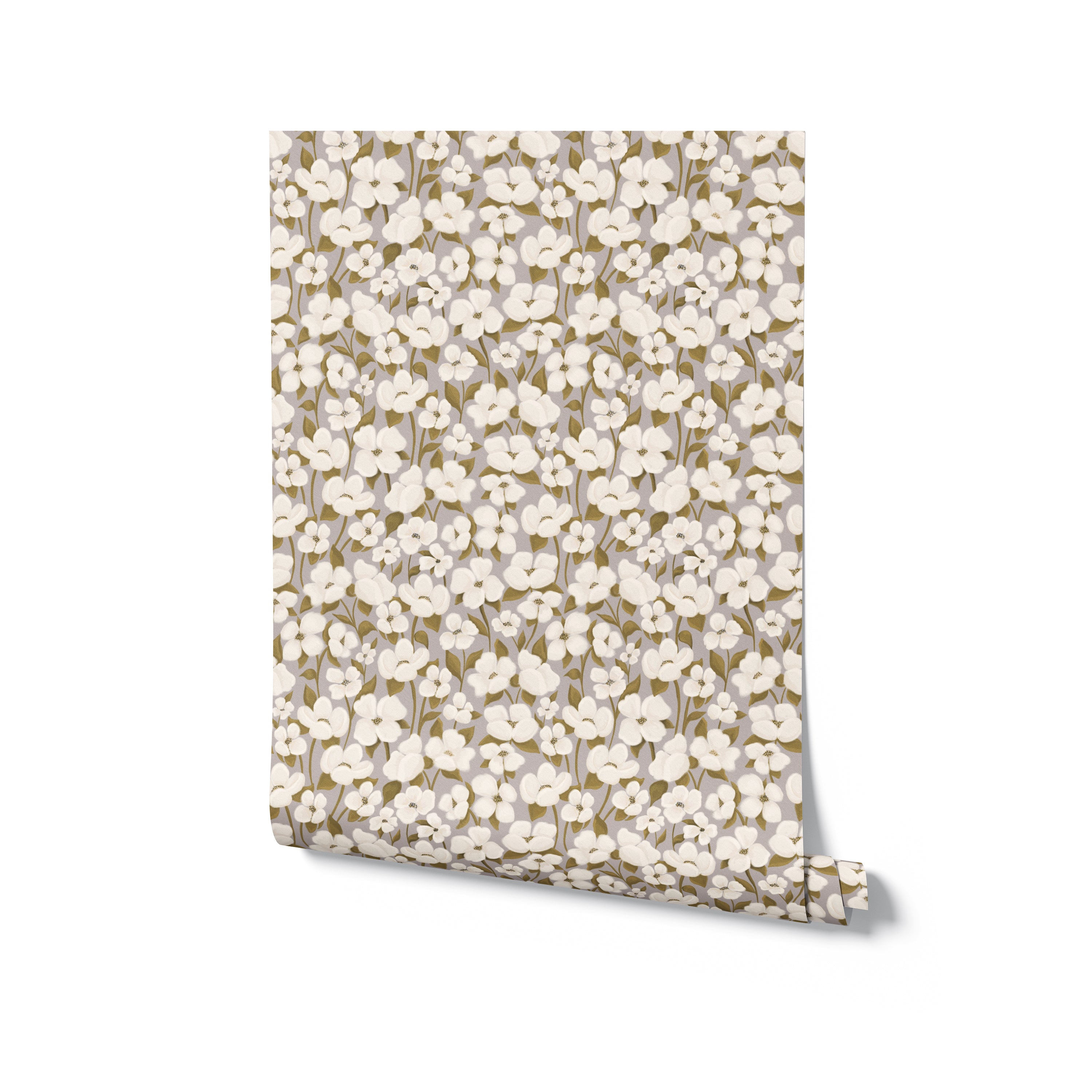 A roll of wallpaper unfurled slightly to show a repeat pattern of white flowers with dark centers and green leaves on a neutral beige background. The pattern is dense and organic, reminiscent of a spring meadow, perfect for creating a fresh, airy feel in an interior space.