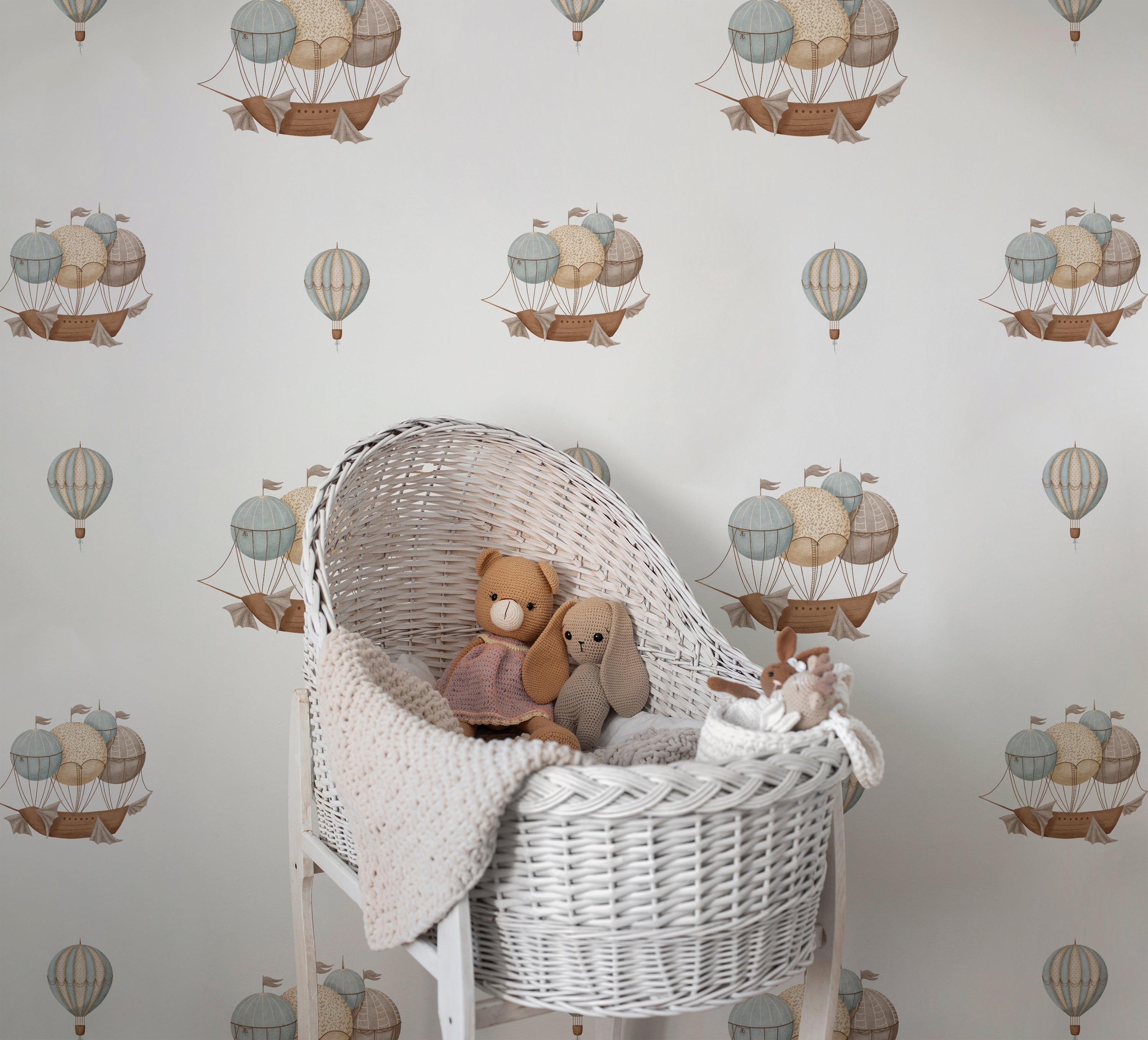 Nautical Balloons Wallpaper in a nursery with a wicker bassinet, enhancing a cozy, whimsical atmosphere.