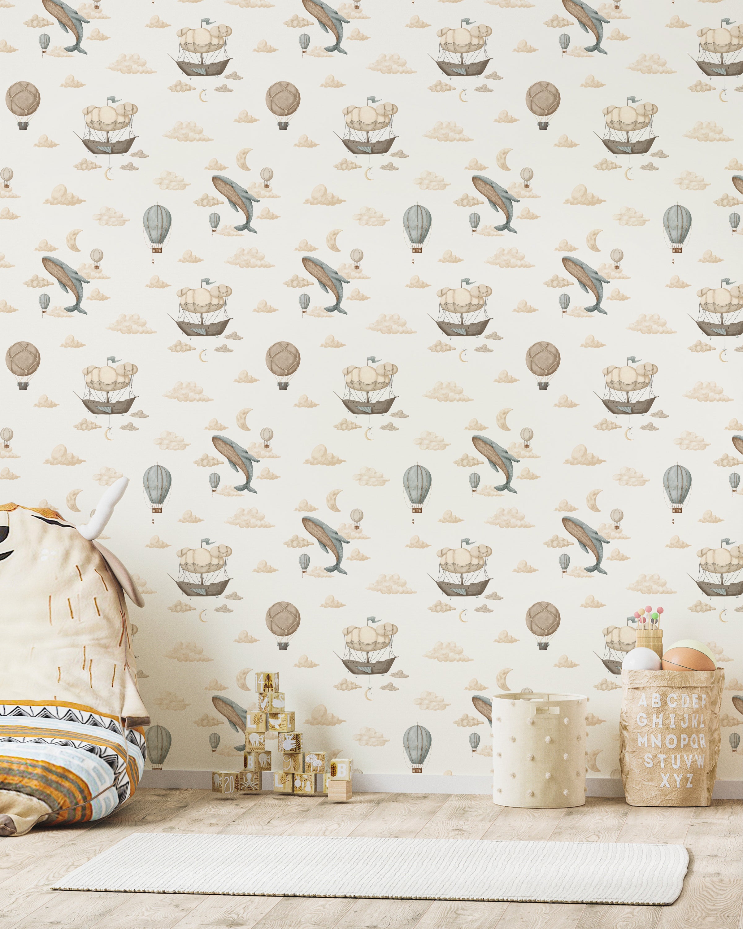 A playful nursery with Cloudy Voyages Wallpaper, adorned with whimsical airships, balloons, and clouds. Soft toys and blocks enhance the room's enchanting atmosphere.