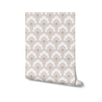 A roll of 'Scallop Mosaic Wallpaper' partially unrolled, displaying the elegant beige and white scalloped pattern. This image highlights the wallpaper's potential to enhance home decor with its graceful and timeless design.