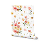 Rolled view of the Golden Garden Wallpaper displaying the vibrant floral pattern with pink, yellow, and white flowers on a white background.