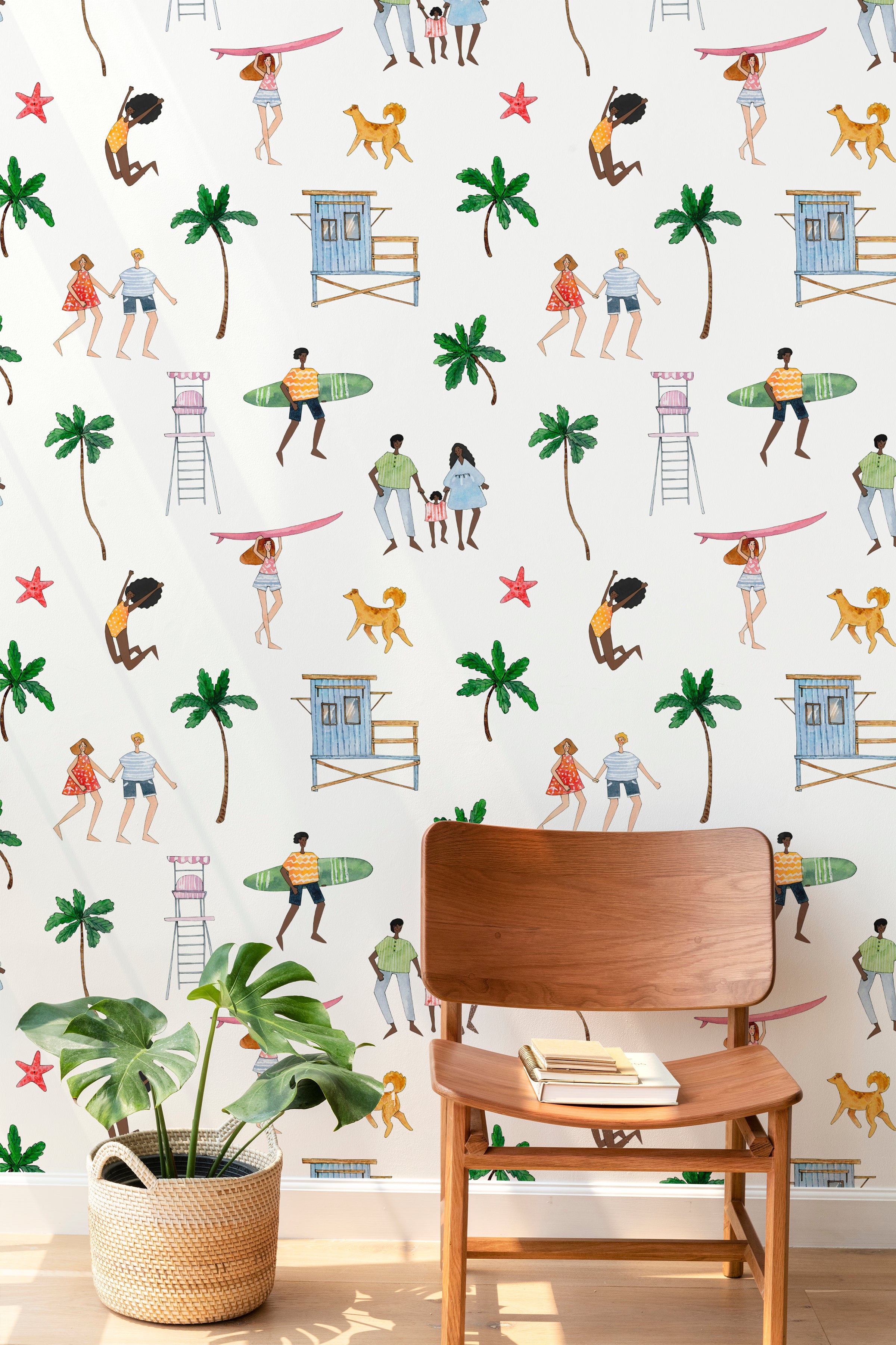 A bright room with Beach Party Wallpaper displaying beach scenes, palm trees, and people surfing. A wooden chair and a plant add a natural touch to the decor.