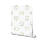 A roll of Smiley Wallpaper showcasing its fun pattern of green smiley faces on a light background, ready to bring a playful touch to any room