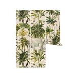 A roll of Elephant and Palm Wallpaper - 75", showcasing the detailed artwork of jungle wildlife and verdant foliage. The design transports viewers to a tropical forest, making it ideal for those looking to bring the outdoors inside their living space.