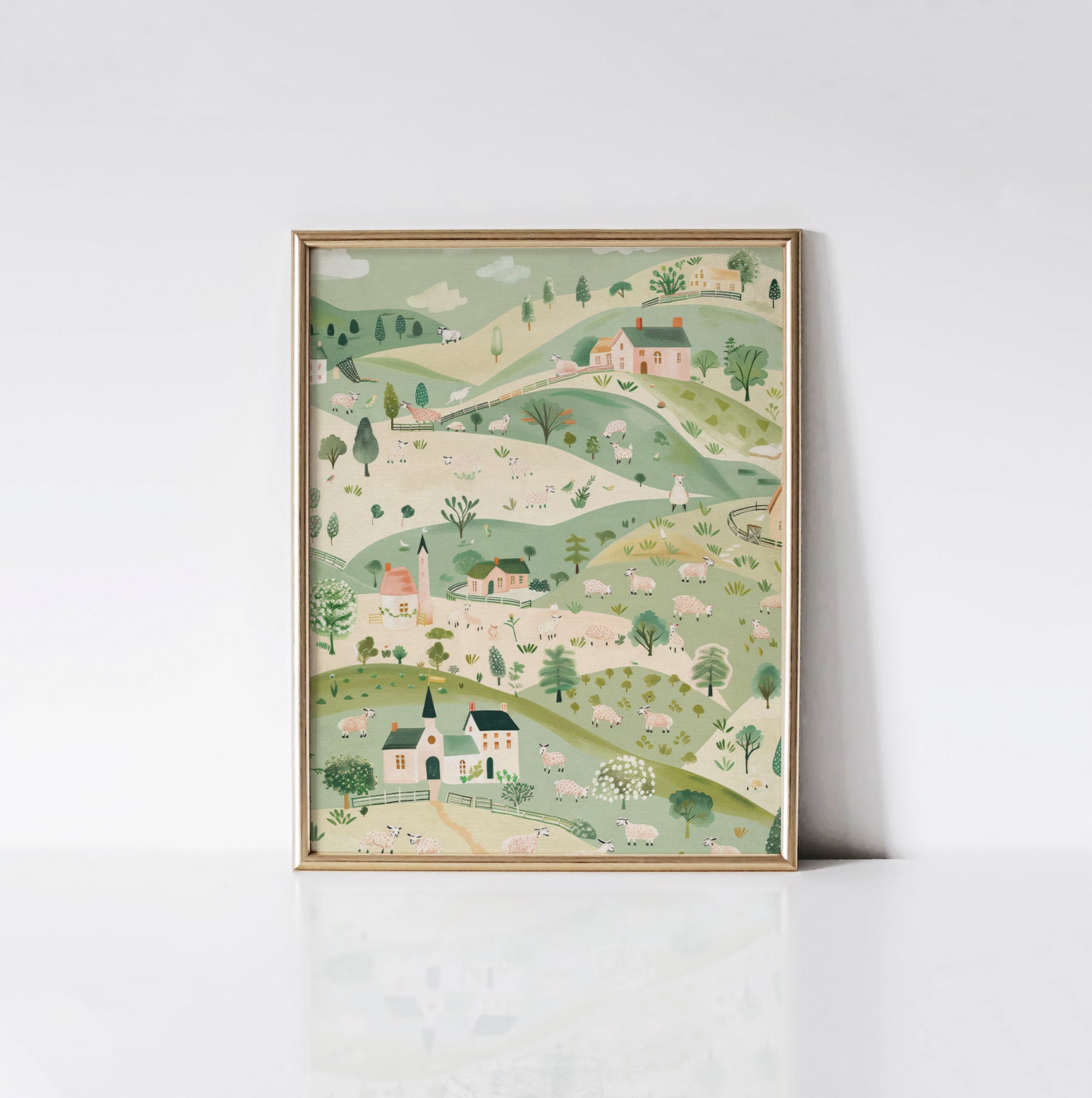 The "Pastoral Playground" art print displayed in a gold frame, showcasing a delightful countryside landscape with sheep, cottages, and rolling green hills.