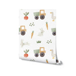 A roll of Farm Friend Wallpaper - Bunnies and Gosling, displaying a delightful pattern of bunnies, geese, tractors, carrots, radishes, and grass on a white background, perfect for adding a fun touch to any room.