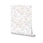 A roll of Winter Branches Wallpaper displaying a beautiful pattern of beige botanical designs with leaves and buds on a white background, perfect for adding a touch of elegance to any room.