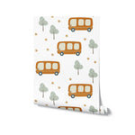 A roll of School Bus Wallpaper displaying a repetitive and engaging pattern of orange school buses, light blue trees, and golden stars, perfect for enriching the environment of a nursery or child's play area with a fun and educational theme