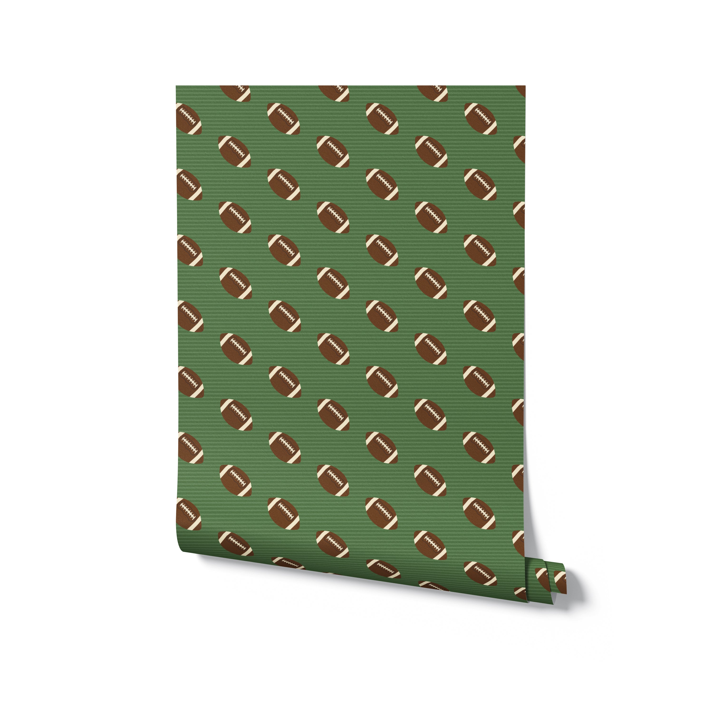 A single roll of Football Frenzy wallpaper unrolled to display its sporty pattern of brown footballs with white stripes on a green striped background.