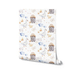 Roll of 'Watercolor Farm Animals VI' wallpaper showing a detailed and whimsical farm scene with geese, chicks, farmhouses, and clouds in soft watercolor tones on a white background, ideal for adding a touch of rustic charm to any room