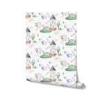 A roll of Watercolor Farm Animals IV wallpaper with a repeating pattern of artistic windmills, sheep, trees, and clouds, painted in soft watercolor style on a white base, ideal for a serene nursery or playroom.