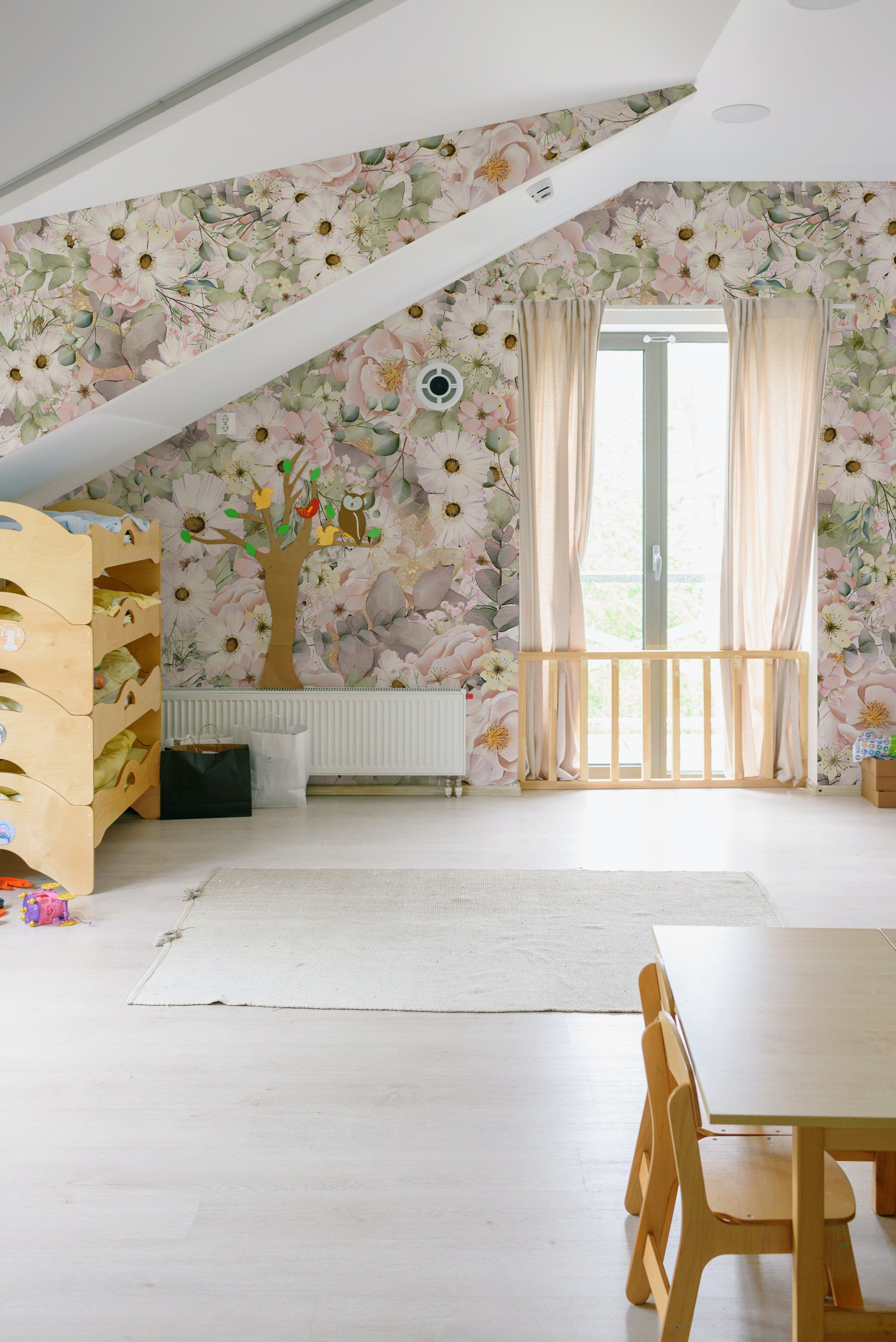 A spacious room adorned with Pink Fleur Wallpaper - 75" on the sloped ceiling and walls, creating a bright and floral ambiance. The wallpaper's detailed pink flowers and greenery complement the natural light entering through the windows