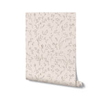 A roll of elegant floral wallpaper featuring a continuous line drawing of flowers and leaves, suggesting a minimalist yet warm design suitable for a variety of contemporary interiors.