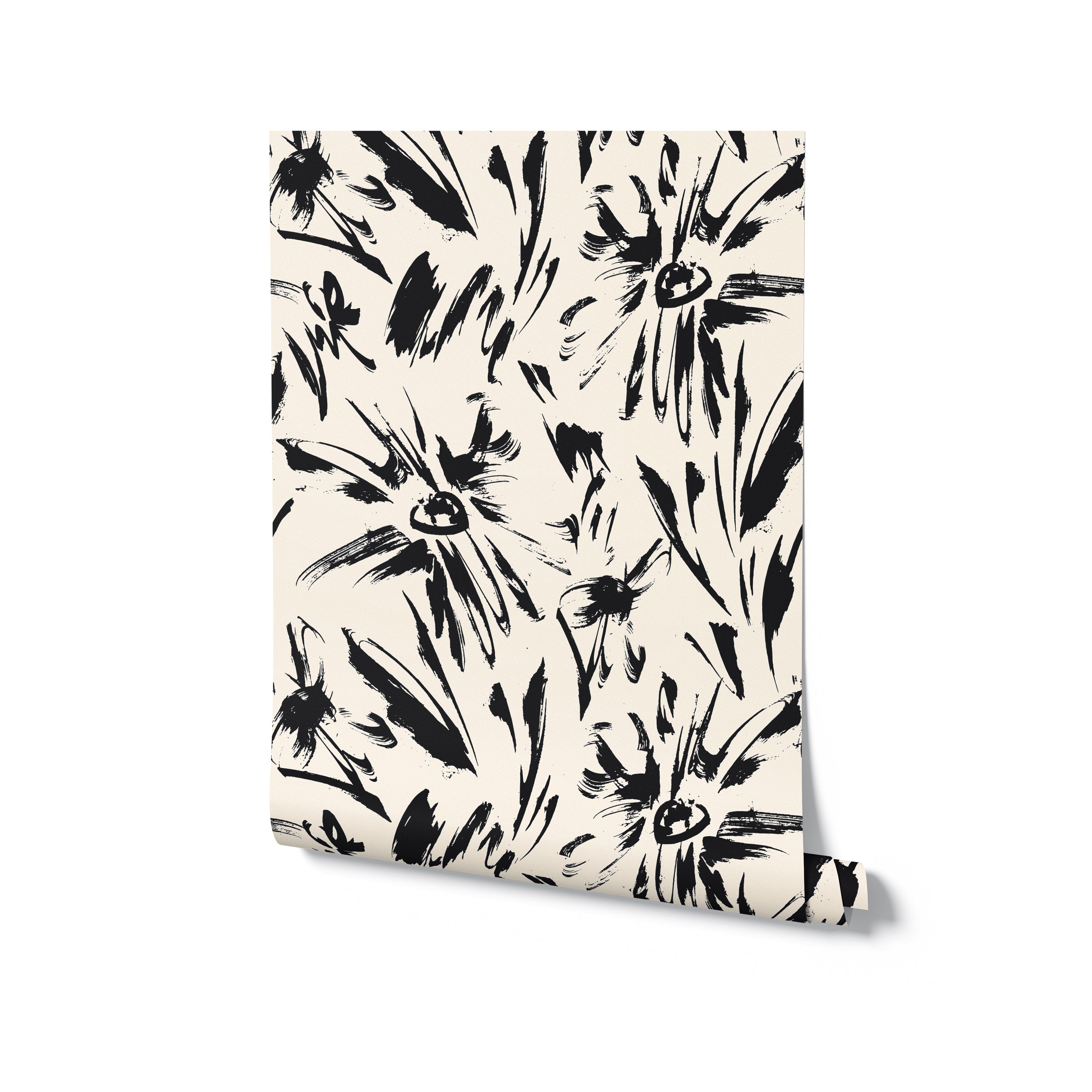 A roll of Modern Floral Sketch Wallpaper - 25", partially unrolled to reveal the distinctive black abstract floral designs on a clean white background. This bold and artistic wallpaper is perfect for making a statement in any modern or eclectic interior design.
