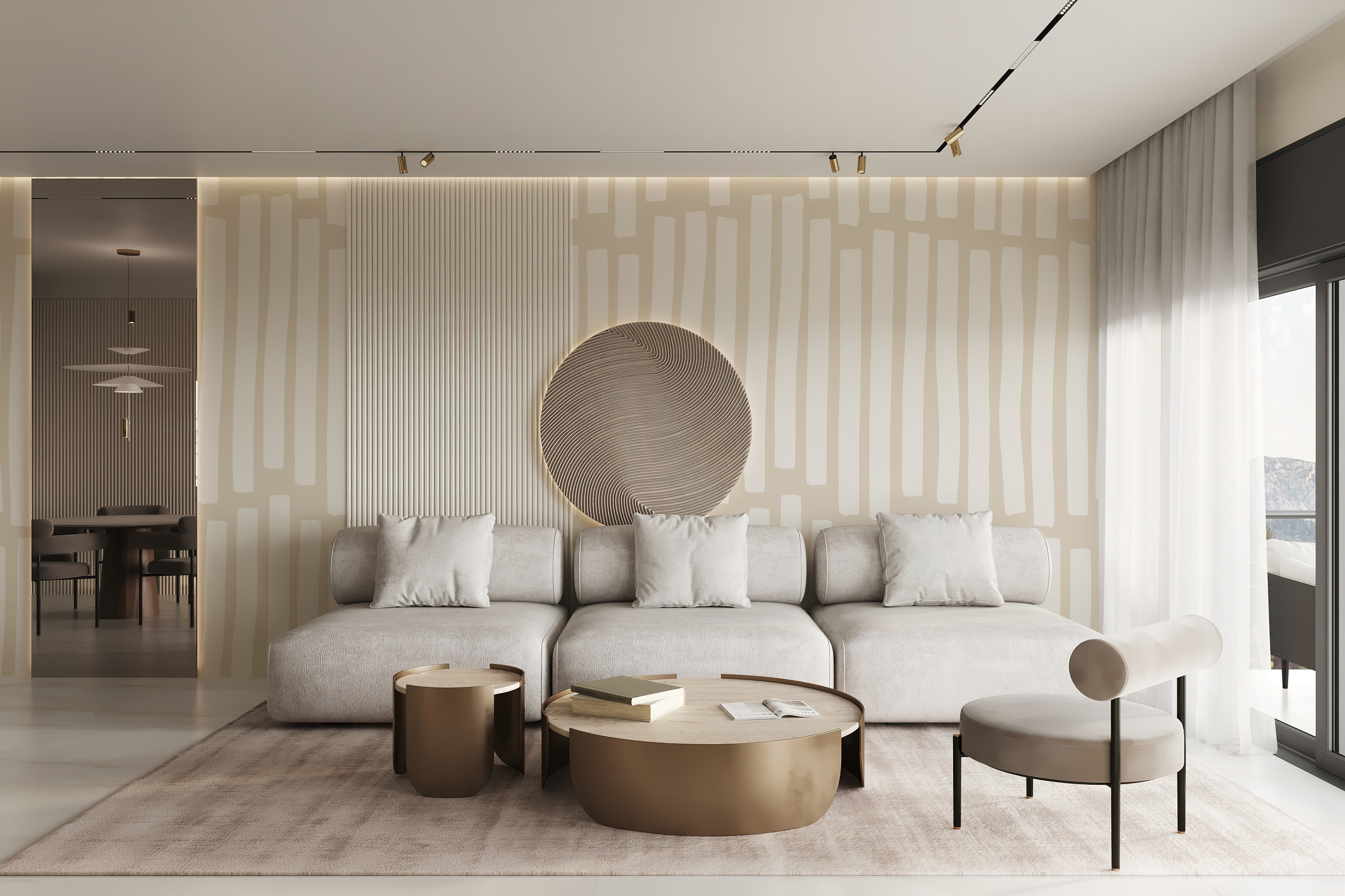A modern living room showcasing the Boardwalk Wallpaper - 100" on the wall behind a plush gray sofa set. The decor includes a unique round mirror and a large metallic coffee table, harmonizing with the wallpaper's neutral tones to produce a refined and contemporary look.