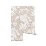 A roll of the Floral Beauty Wallpaper, unrolled slightly to reveal the detailed floral patterns in white on a neutral taupe background, perfect for adding an artistic and serene atmosphere to any room.
