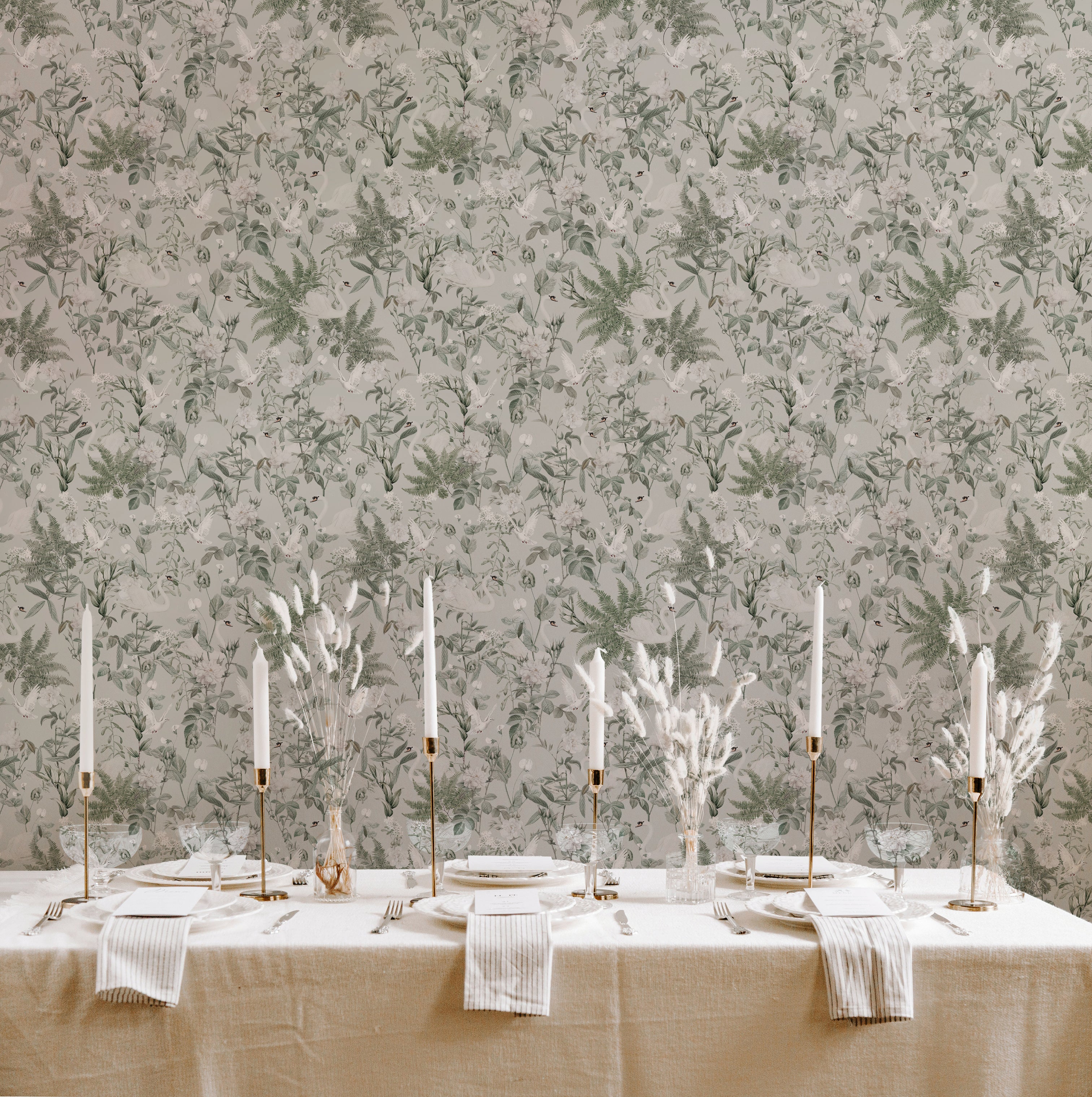A dining room beautifully decorated with Sage Bird Wallpaper, creating a tranquil and refined atmosphere. The wallpaper's detailed botanical and bird motifs in shades of green and white complement the classic and elegant dining setup.