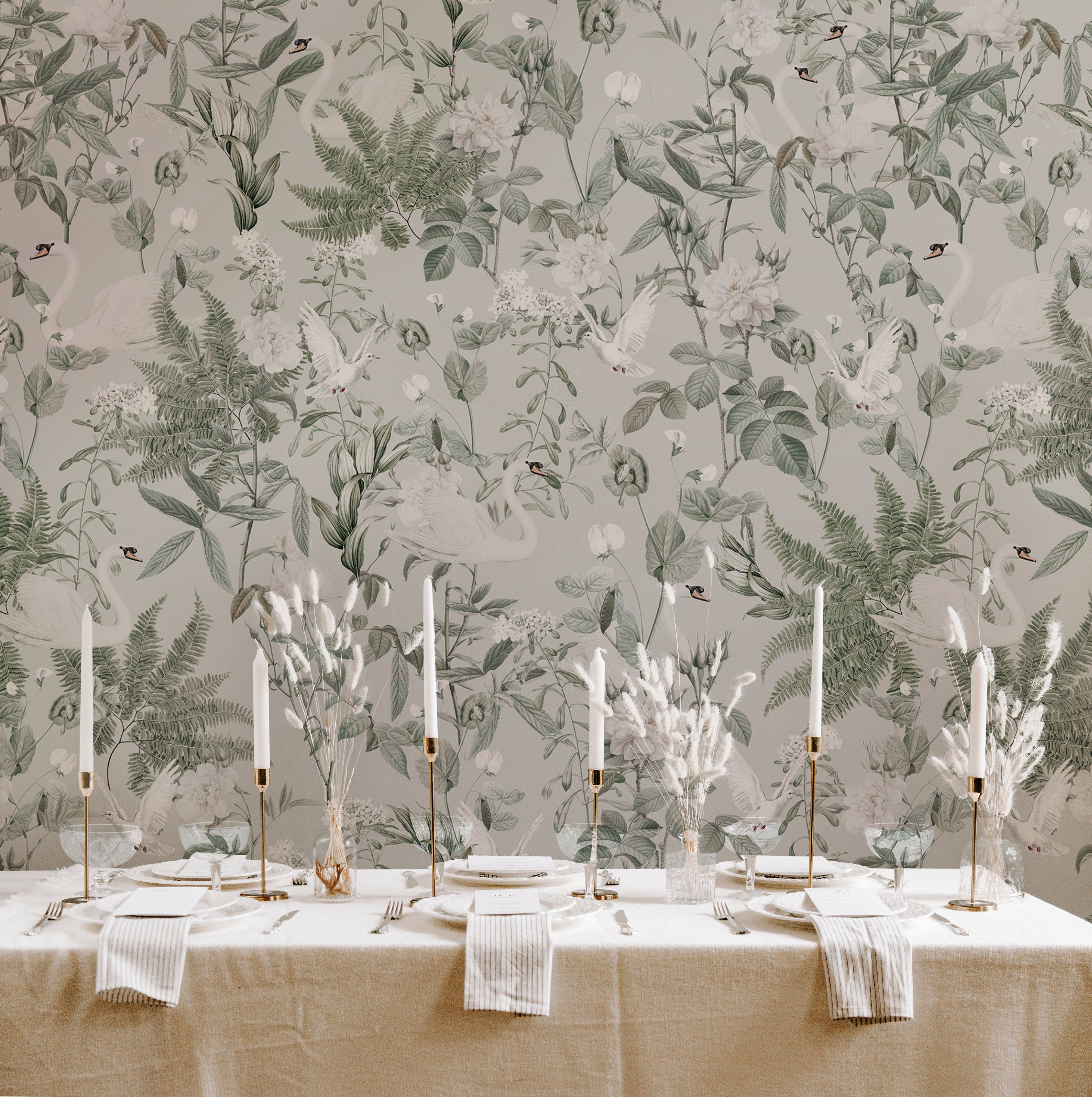 A sophisticated dining room wall covered with Sage Bird Wallpaper, presenting a tranquil nature scene with elegant swans and diverse flora in muted green and white tones, enhancing the room's classic decor.