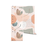 Rolled view of the Modern Watercolour Abstract Wallpaper featuring a dynamic arrangement of watercolor splotches in shades of peach and teal, accented with small black dots and thin black lines, perfect for a contemporary home