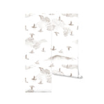 a roll of the Kids Wild Pinery Wallpaper, giving a detailed view of the elegant bird design that continues across its length. This image highlights the seamless nature of the wallpaper's pattern, indicating how it will maintain its whimsical forest atmosphere across an entire wall or room, wrapping the space in the tranquil beauty of the wilderness.