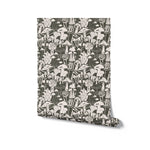 A roll of green wallpaper with a playful mushroom print in cream, displaying a variety of forest fungi that add a touch of whimsy to any room decor
