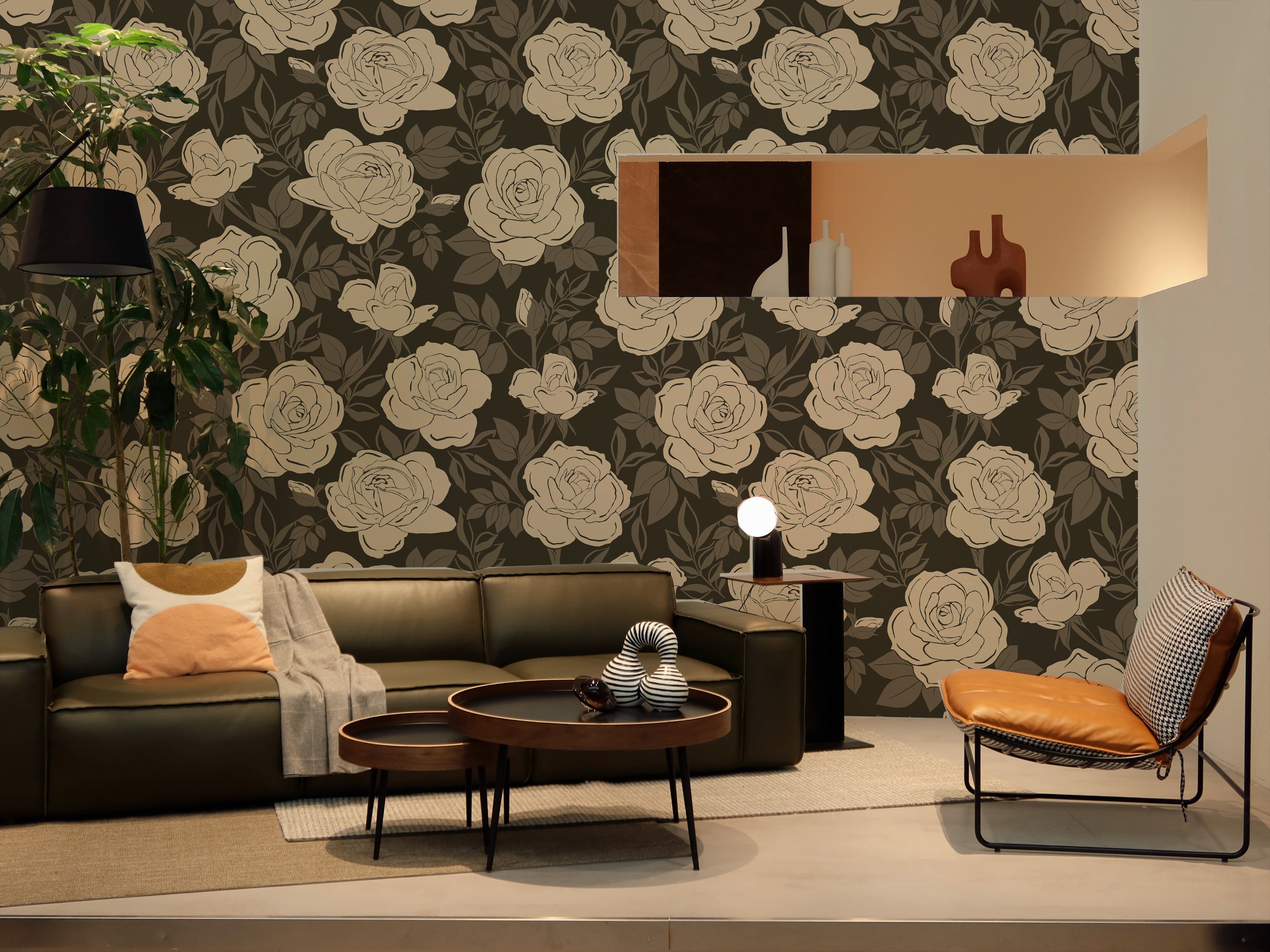 Modern living room featuring a large, elegant floral wallpaper with cream roses on a dark gray background. The space includes a dark leather sofa, designer chairs, and wood accent furniture, creating a sophisticated and inviting atmosphere.