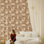 A cozy bedroom featuring a wooden ladder, a large bed with white bedding, and a light curtain adorned with star patterns. The room is decorated with the Rosehip Wallpaper, which displays a rich floral pattern with large white blooms and smaller pink flowers against a dark backdrop, adding a warm and inviting atmosphere.