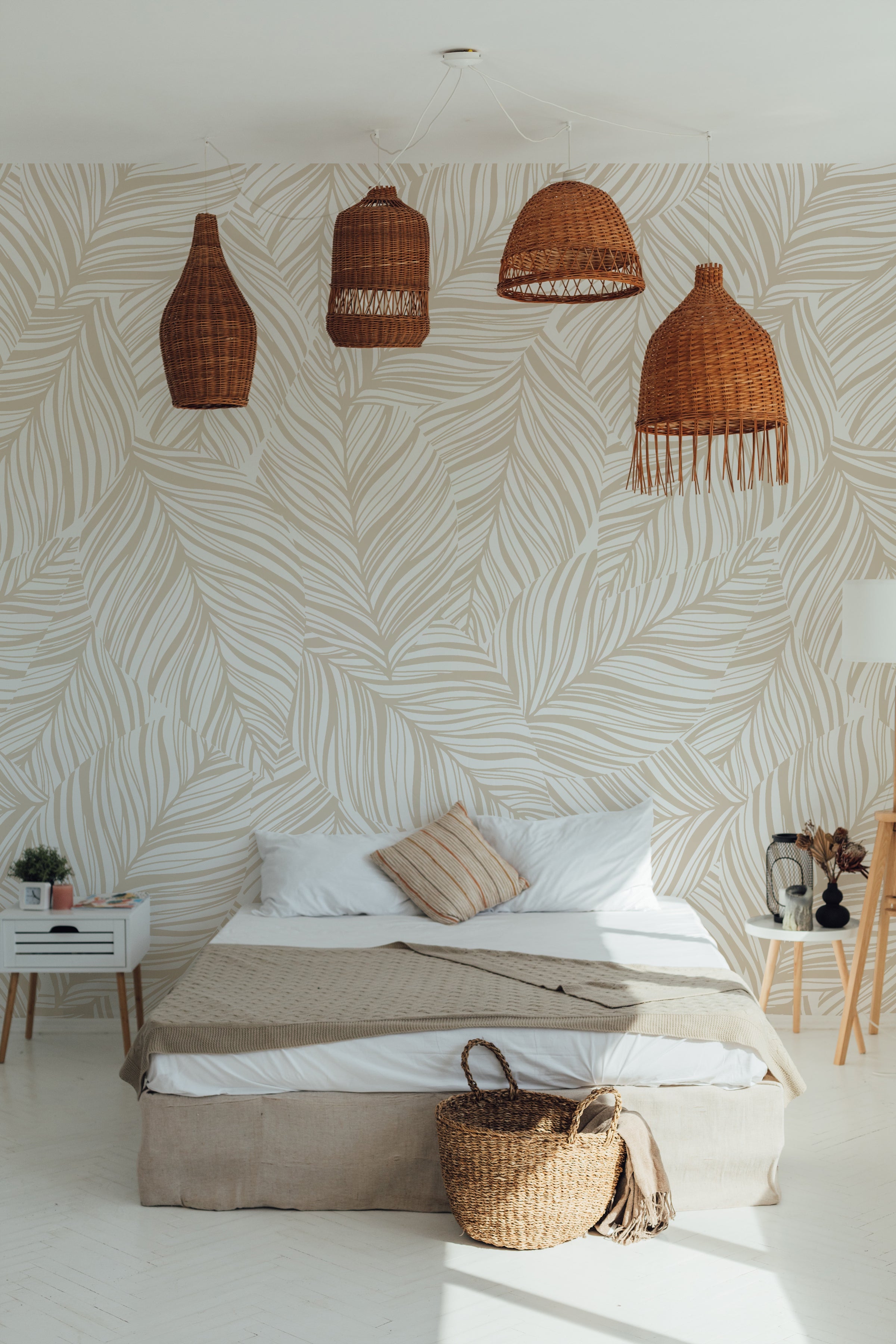 A stylish bedroom setting with Abstract Leaf Wallpaper creating a soothing backdrop. The room features a low-profile bed with simple bedding, woven rattan light fixtures above, and minimalist decor, all harmonizing with the leafy wallpaper to evoke a calm and serene environment.