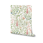 A digitally depicted roll of Watercolour Floral and Leaf Wallpaper, showing off a painterly arrangement of flowers and leaves in a watercolor style. The soft pastels and vibrant greens suggest a fresh, spring-like atmosphere, perfect for interior spaces that aim to capture the essence of a blooming garden.