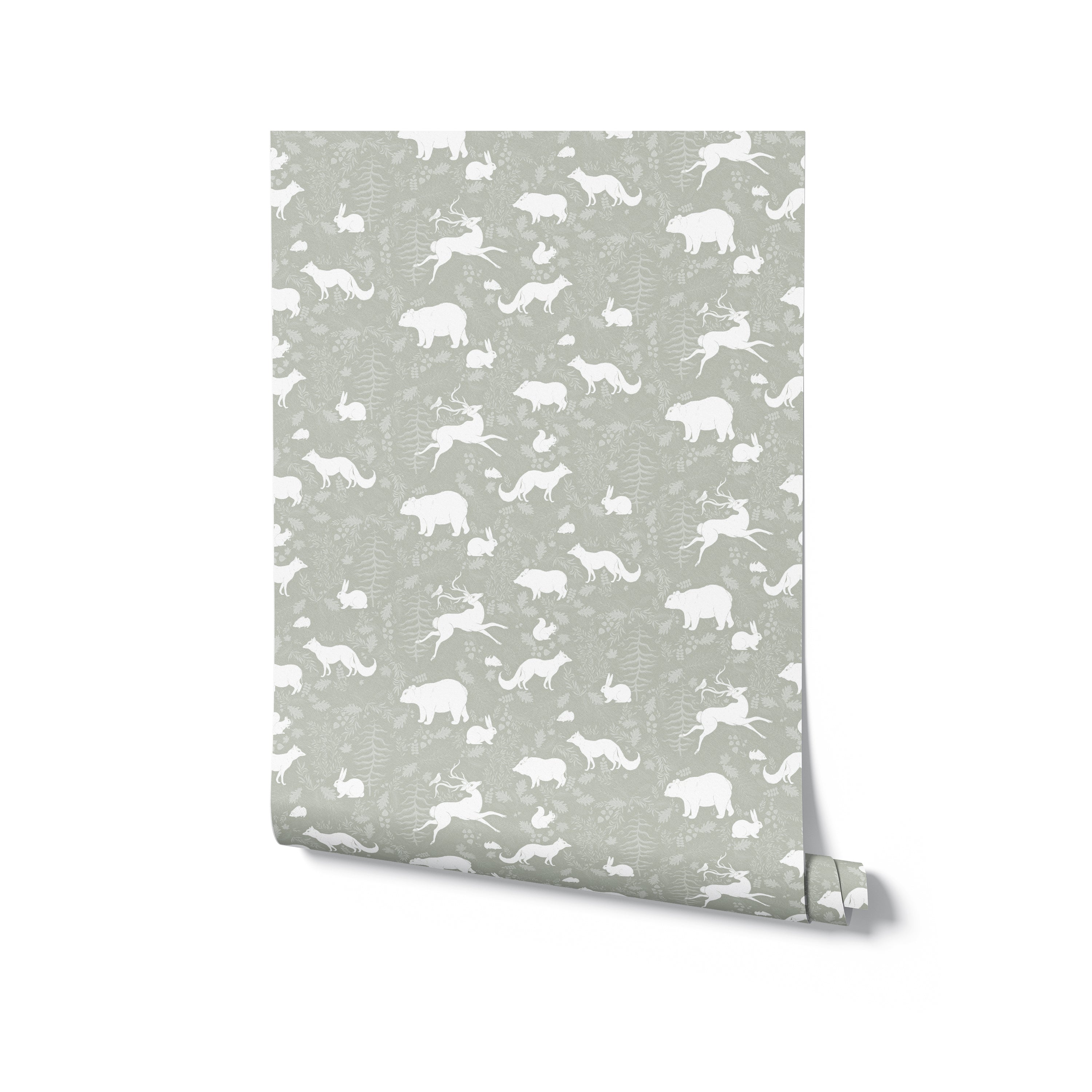 A roll of Forest Silhouettes Wallpaper displaying its white animal silhouettes and foliage pattern on a muted green background. The wallpaper is neatly rolled, highlighting the whimsical and nature-inspired design, perfect for a nursery or children's room.