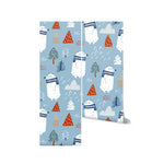 A roll of "Polar Bear Express Wallpaper" showcasing a series of whimsical polar bears in scarves with a mix of trees and mountain motifs in white, gray, and orange on a serene blue background. Perfect for adding a cheerful and imaginative touch to children’s spaces.