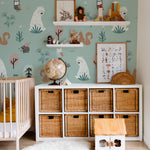 This nursery room is beautifully adorned with "Kids Wallpaper - Forest Critters - 50 inches." The wallpaper features large prints of friendly woodland creatures such as bears, owls, and squirrels in a whimsical forest setting. The room is furnished with a white crib, rattan storage baskets, and playful decor, creating a charming and inviting space for children.