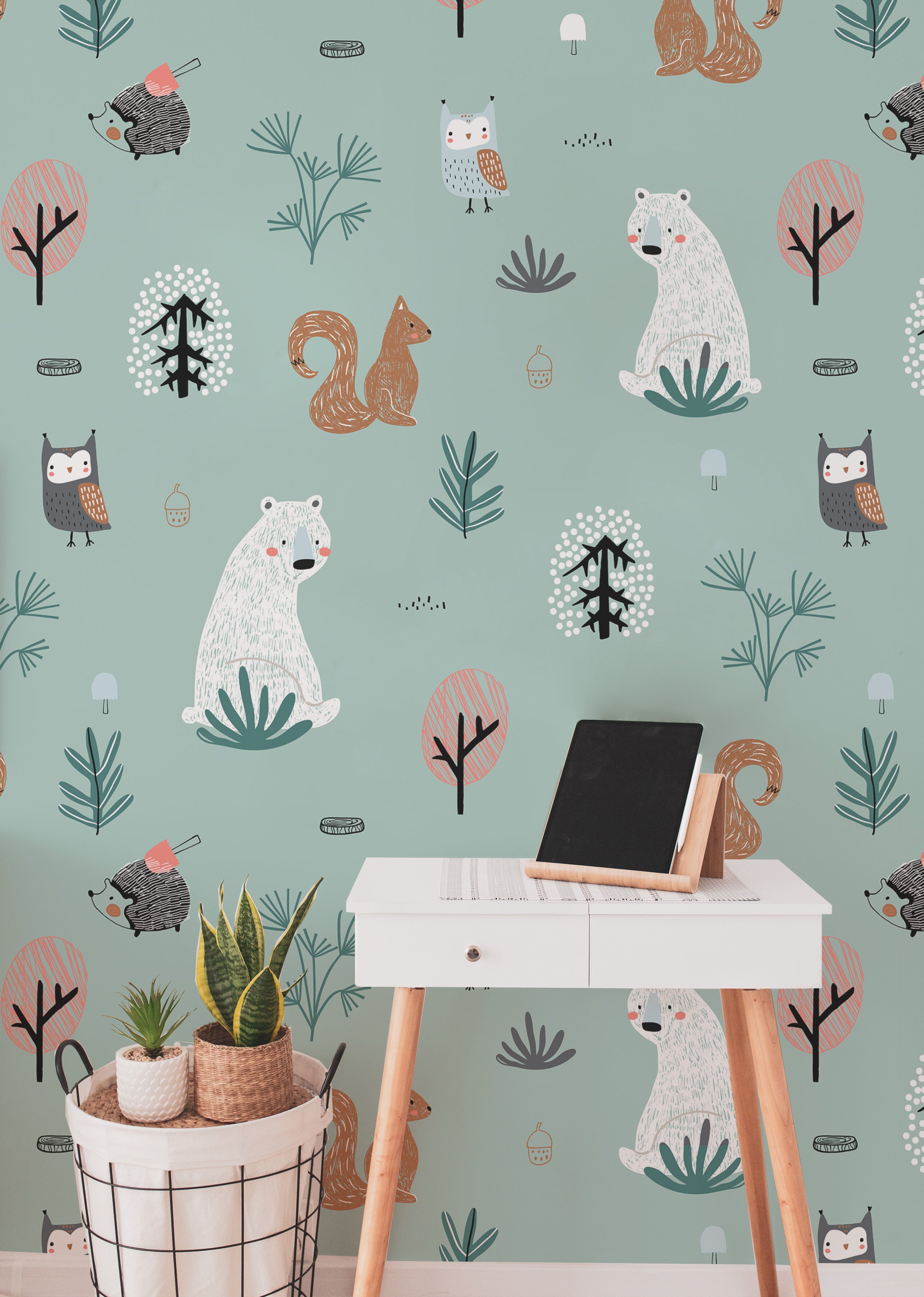 A workspace is transformed with the "Kids Wallpaper - Forest Critters - 50 inches," providing a calming backdrop. The wallpaper features large images of forest animals like bears and owls among trees and plants, enhancing the creative and peaceful atmosphere of the room.