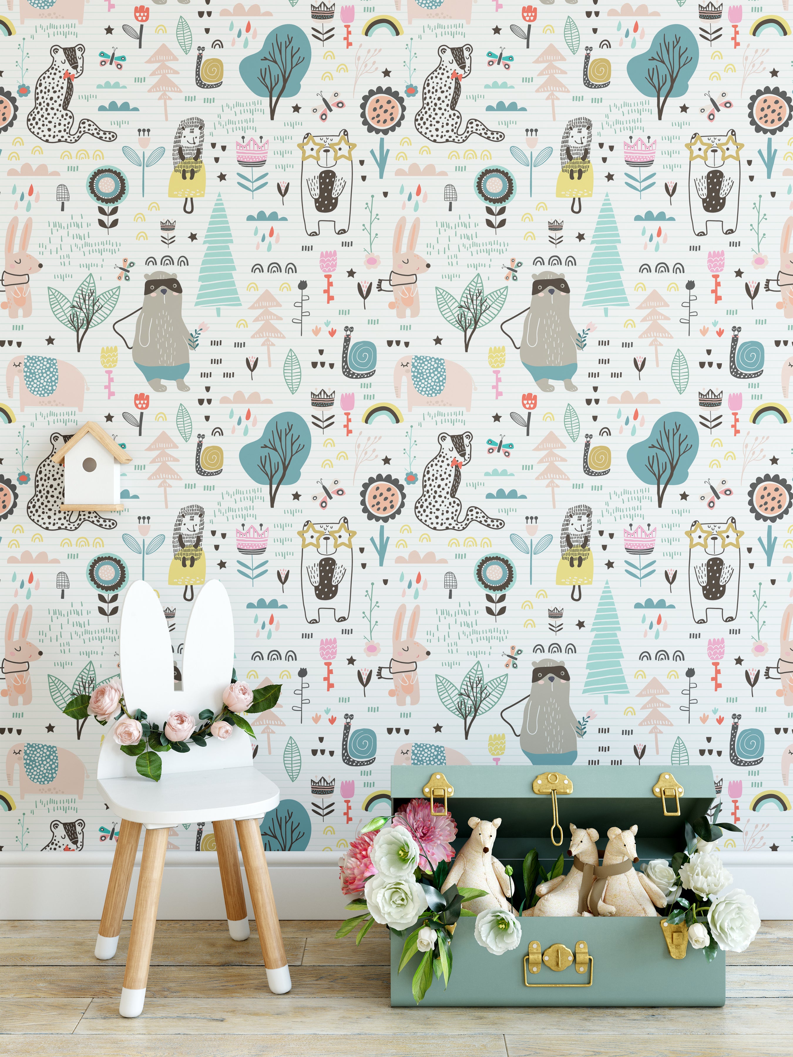 A vibrant children's playroom with walls adorned with "Animal Sketches Wallpaper," featuring whimsical illustrations of various animals and nature elements in playful colors. The scene includes a white stool with bunny ears and a green storage box filled with stuffed animals, creating a charming and imaginative space.