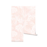 A close-up view of the "Tropical Champagne Wallpaper," highlighting its intricate leaf patterns and the gentle contrast between the pink background and the white designs. This wallpaper offers a tranquil and inviting ambiance, perfect for modern and stylish interior settings.