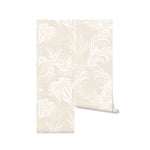 Rolled-up sample of the Tropical Palms Wallpaper with a glimpse of the cream and beige palm leaf patterns, indicative of the wallpaper's overall design and color scheme.