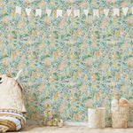 A whimsical nursery room wall decorated with a detailed floral and rabbit print wallpaper. The room's decor includes a fabric teepee, wooden toys, and a minimalist rug, creating a playful yet serene space."