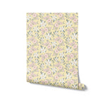 An image showing the Sunny Nursery Wallpaper rolled up, highlighting the detailed floral design with pink and white flowers on a cheerful yellow background, ideal for adding a sunny touch to any child’s room.