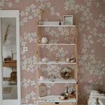 A stylish shelving unit against the Fleur de Printemps Wallpaper in a living room, showing off the wallpaper’s large floral patterns and dotted texture that enhances the room's aesthetic.