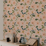 Interior design featuring a wall covered in peach floral wallpaper with furniture including a cabinet and woven baskets