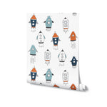 A rolled wallpaper featuring hand-drawn rockets in orange, teal, and navy on a white background, ideal for children's rooms