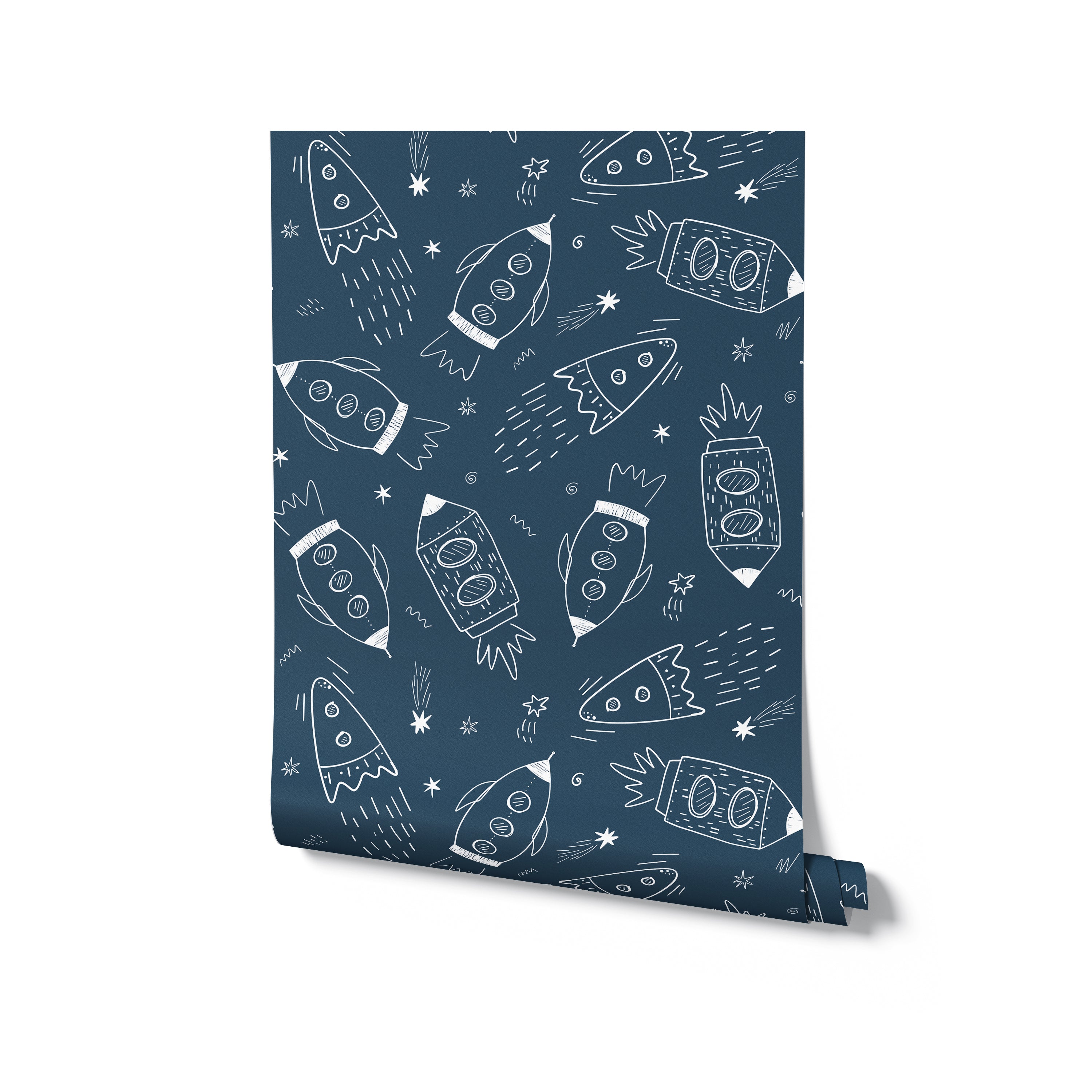 Rolled wallpaper featuring white doodle illustrations of rockets on a navy blue background for a whimsical space theme.