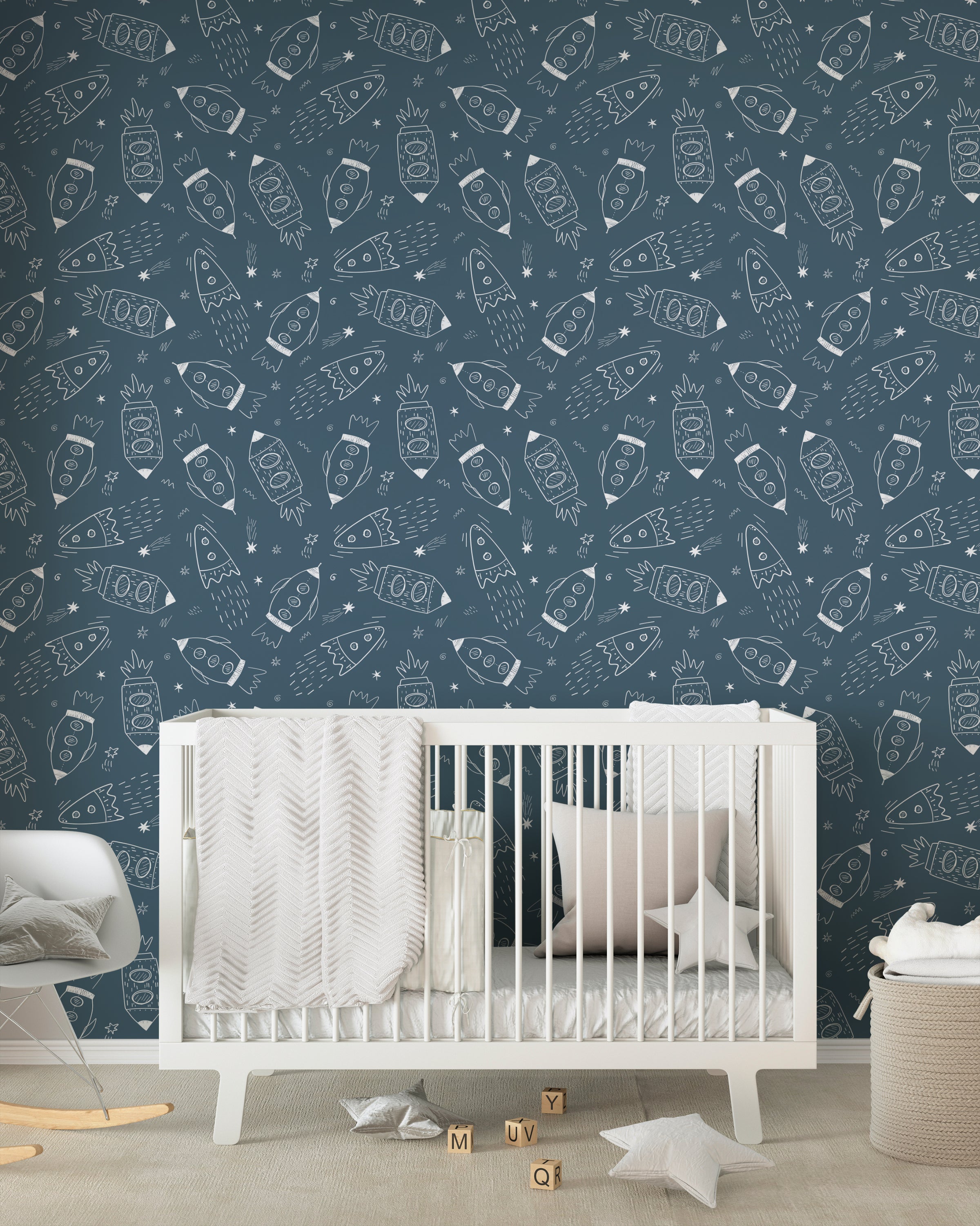 A nursery with walls adorned by 'Cosmic Doodles' wallpaper, complemented by a white crib, star-shaped pillows, and soft, inviting textures.