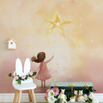 "Playful and magical 'My Guiding Star Mural' in a children's room with a girl reaching up to a bright star."